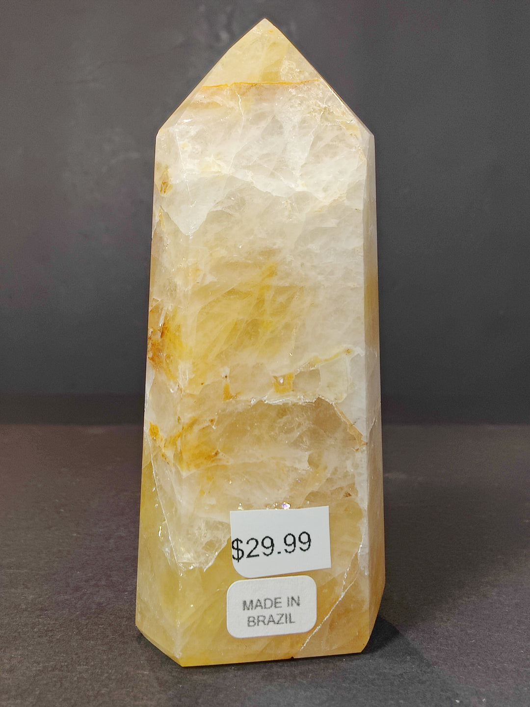 Polished pale yellow quartz obelisk tower sculpture with subtle white veining