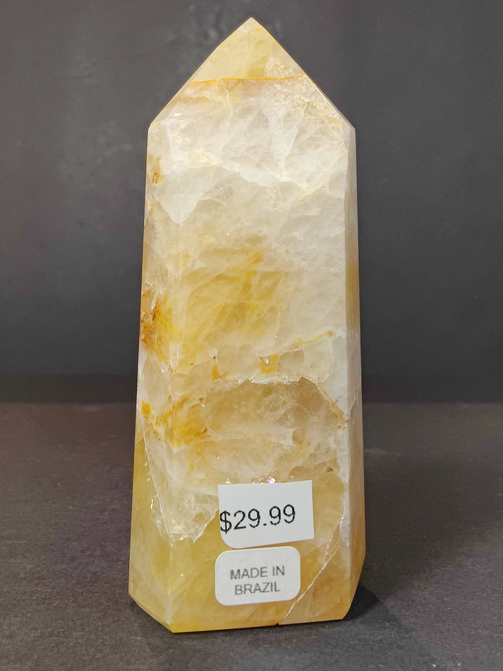Polished pale yellow quartz obelisk tower sculpture with subtle white veining