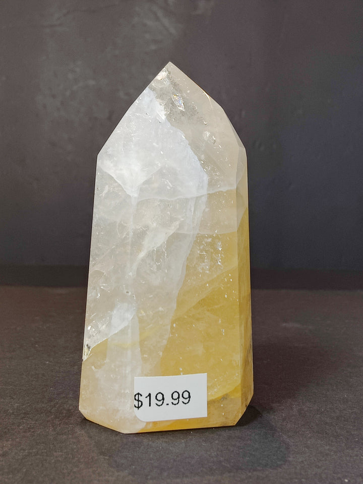 Polished white and pale yellow quartz obelisk tower sculpture with pointed tip