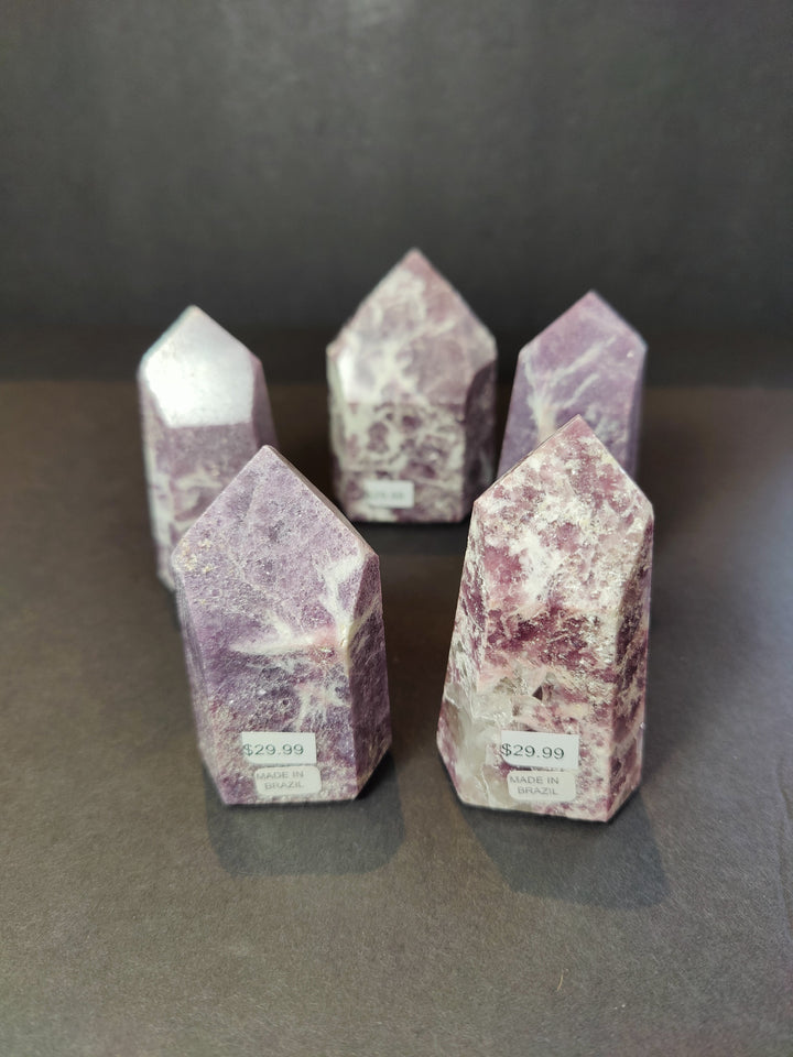 Set of three polished lepidolite tower sculptures, purple with white veining