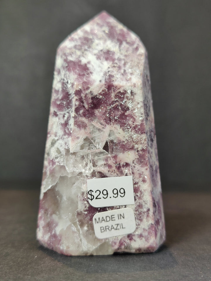 Polished lepidolite tower sculpture, purple and white with Made in Brazil label