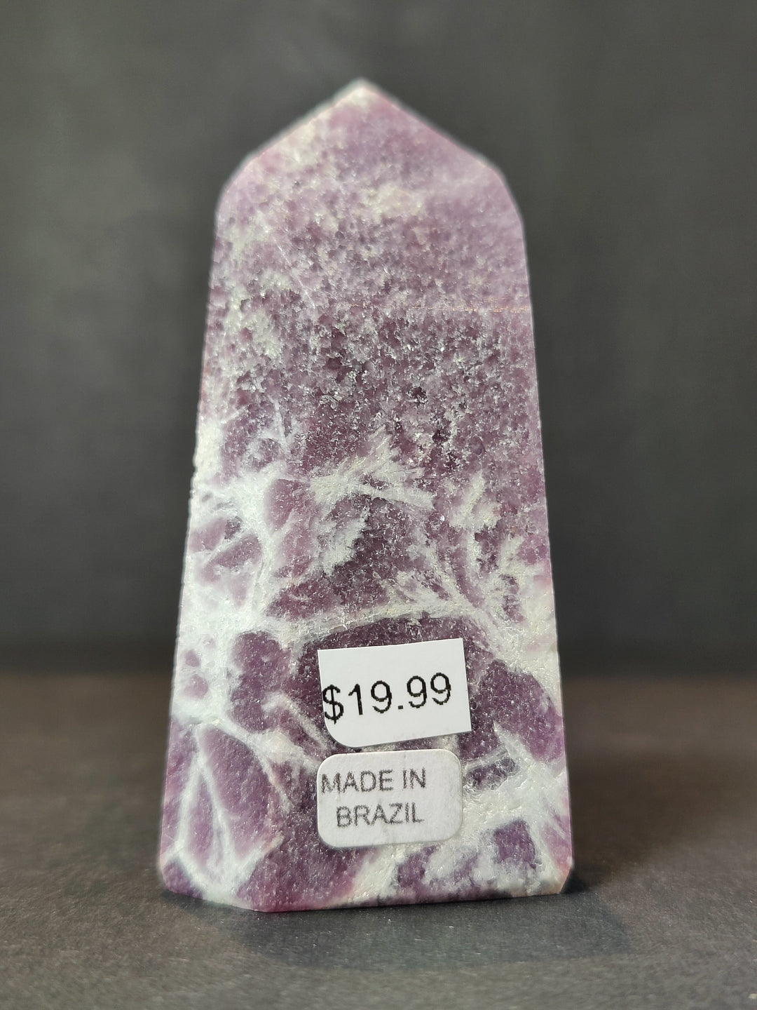 Polished lepidolite tower sculpture, purple and white with Made in Brazil label