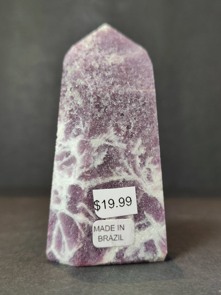 Polished lepidolite tower sculpture, purple and white with Made in Brazil label