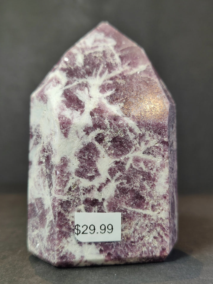 Polished lepidolite tower sculpture, purple-speckled stone with white marbling