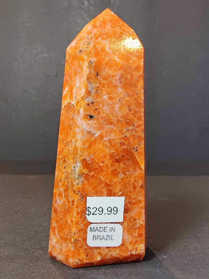 Polished sunstone obelisk tower with &