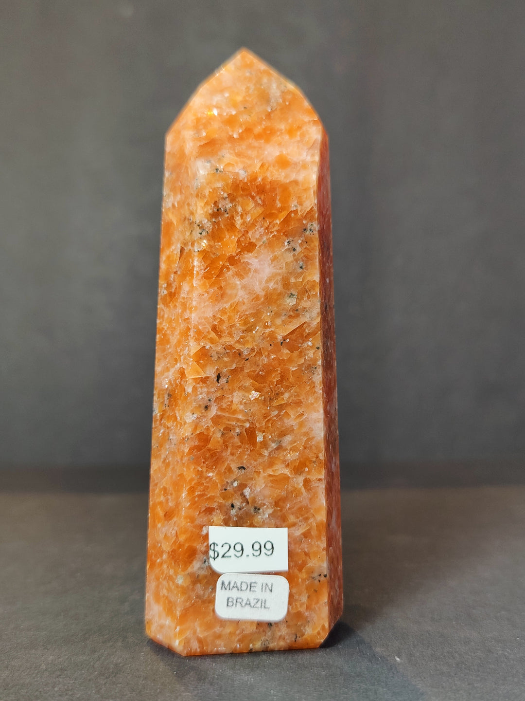 Polished sunstone obelisk tower sculpture, orange with rough crystal face