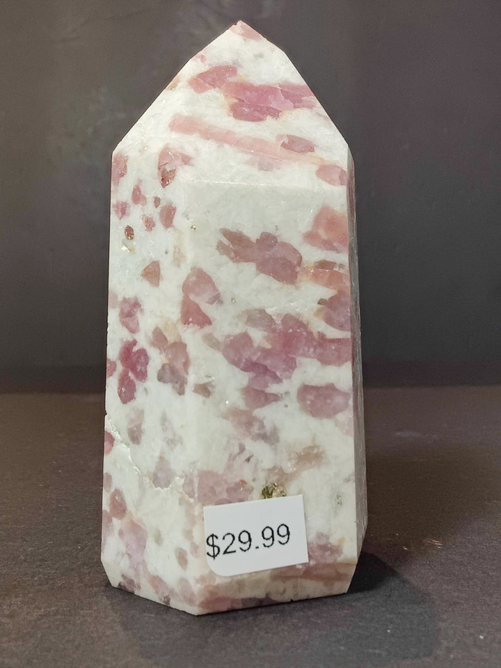Polished quartz obelisk tower with pink streaks and irregular spots throughout