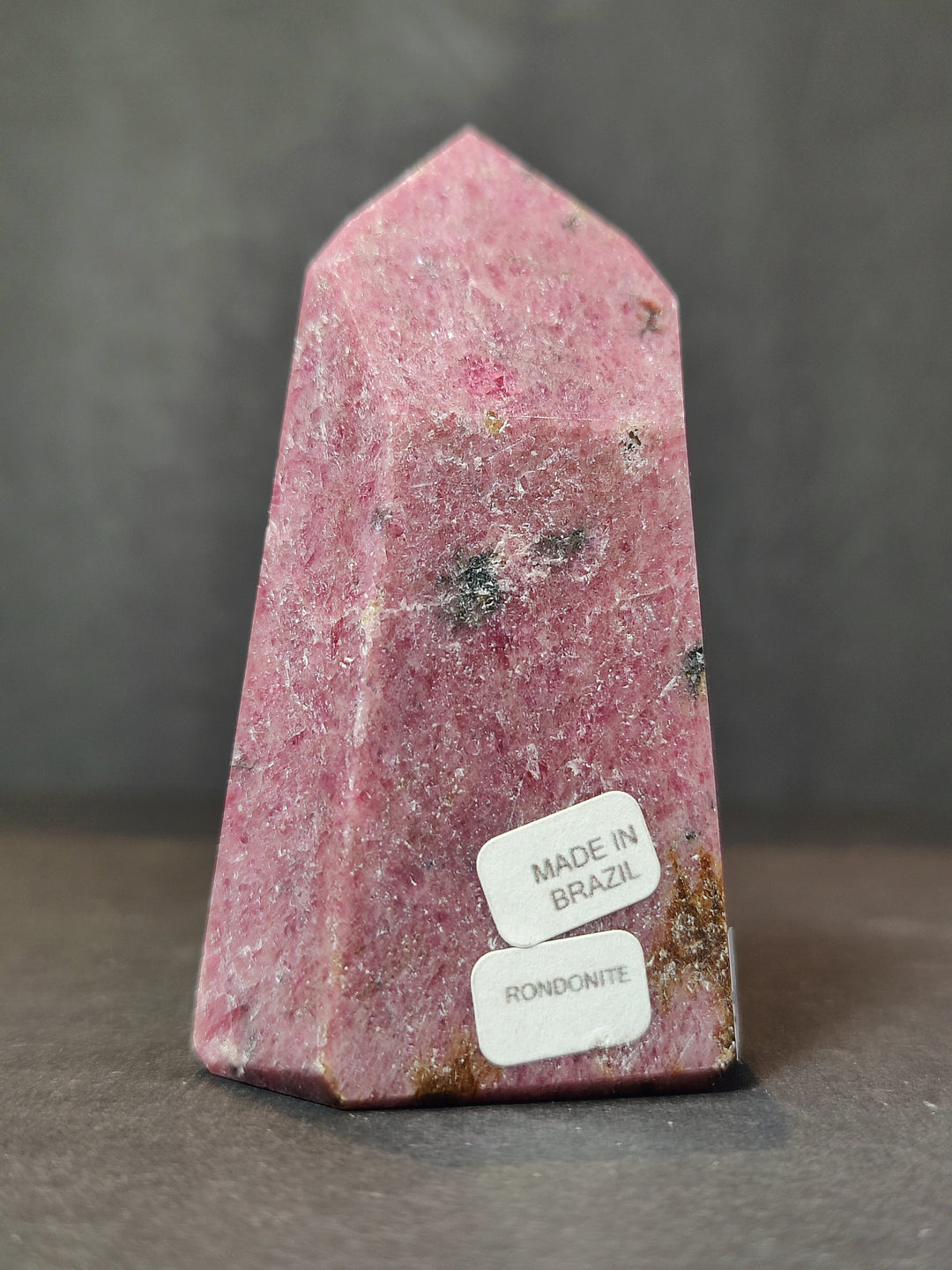 Polished rhodochrosite obelisk tower sculpture, tall pink gemstone with smooth polished top