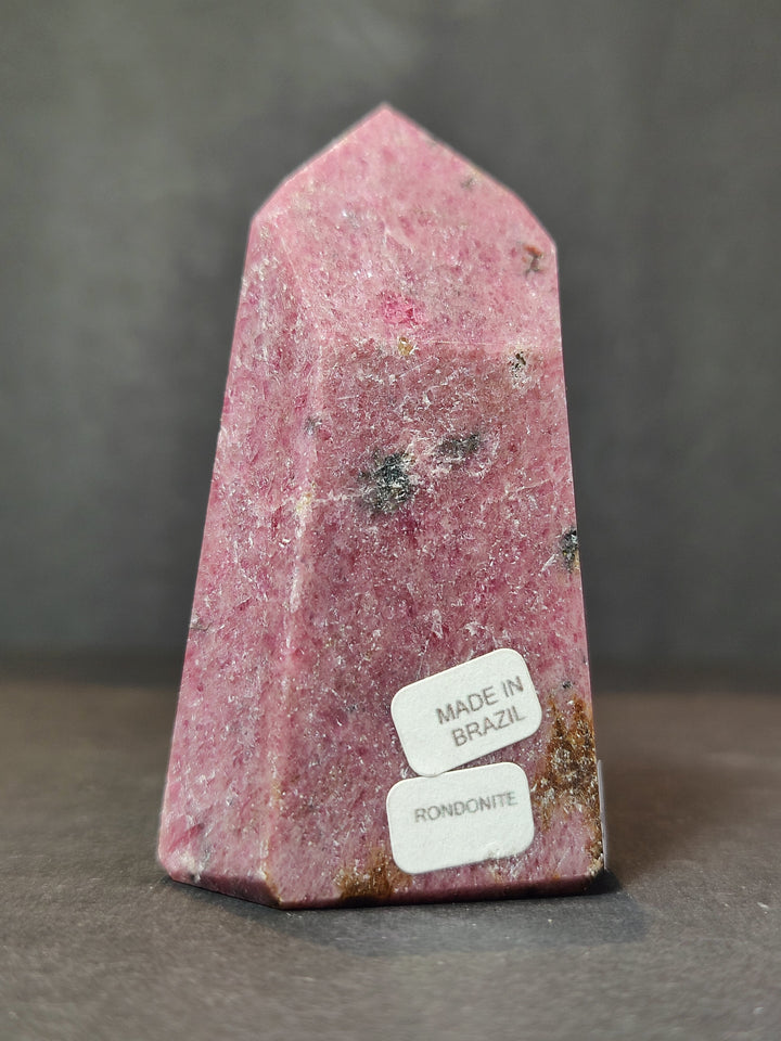 Polished rhodochrosite obelisk tower sculpture, tall pink gemstone with smooth polished top
