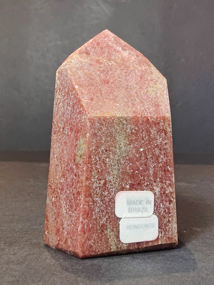 Polished rhodochrosite obelisk tower sculpture, peach-orange stone with polished pointed top