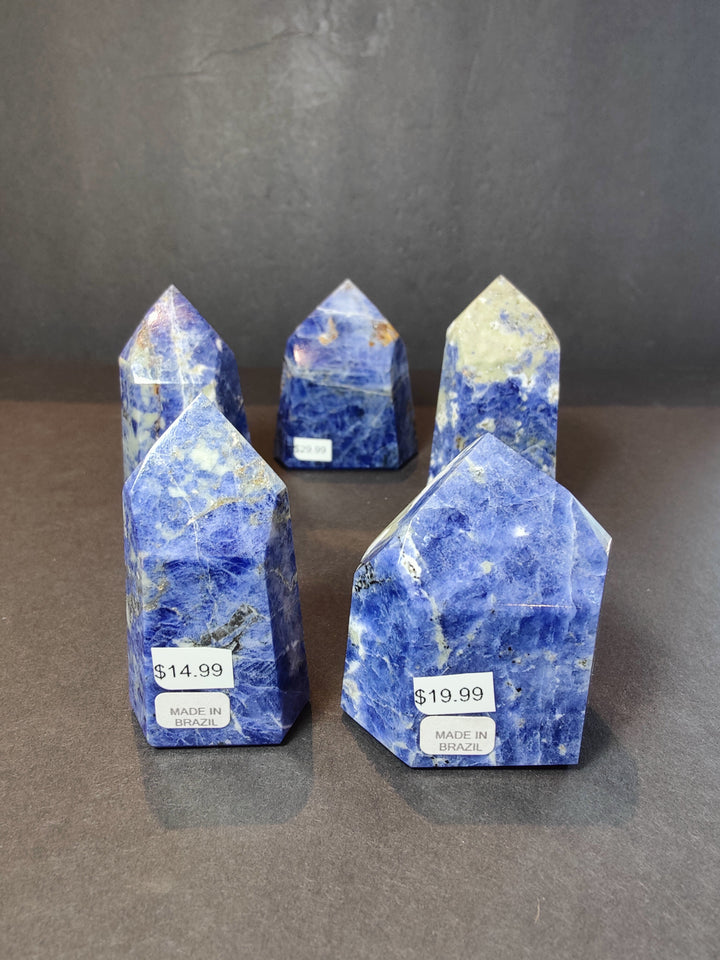Polished blue sodalite obelisk towers, multiple pieces with $14.99–$19.99 tags.