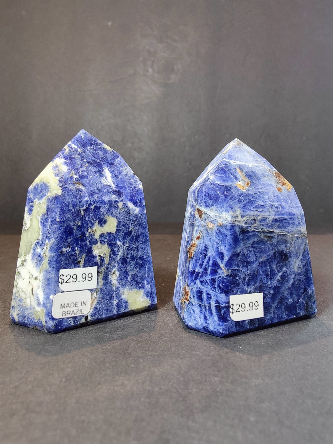 Polished blue sodalite obelisk towers, two pieces with $29.99 tags made in Brazil.