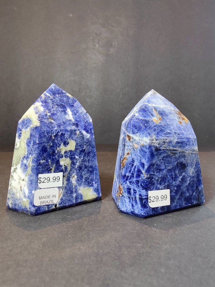 Polished blue sodalite obelisk towers, two pieces with $29.99 tags made in Brazil.