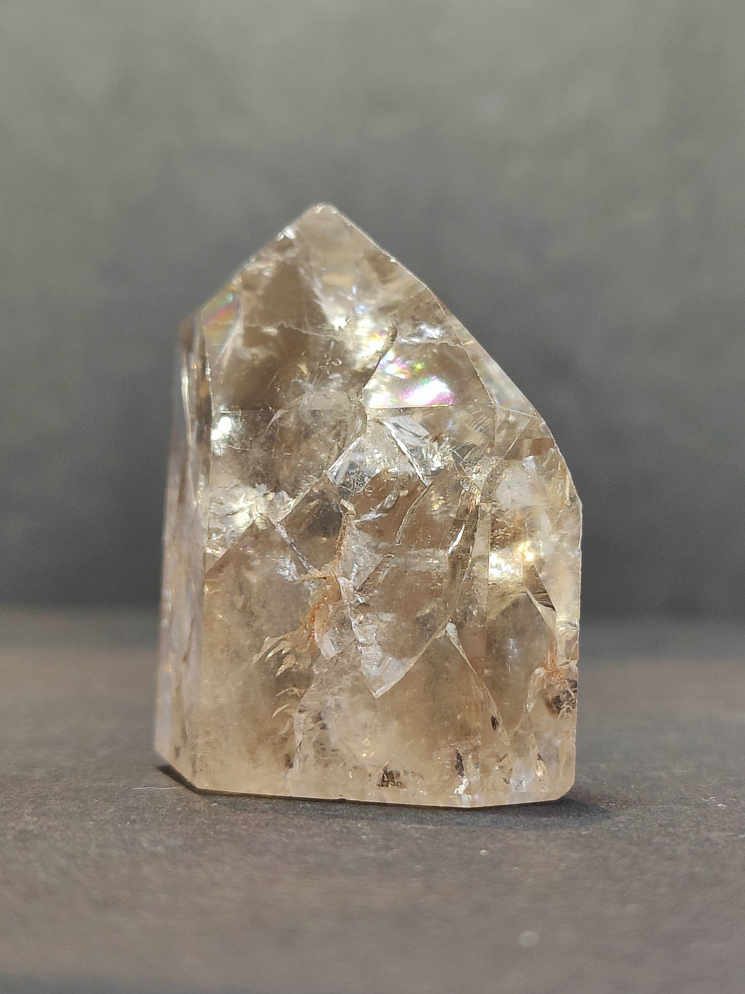 Single smoky gold crackle quartz point with faceted crystal facets