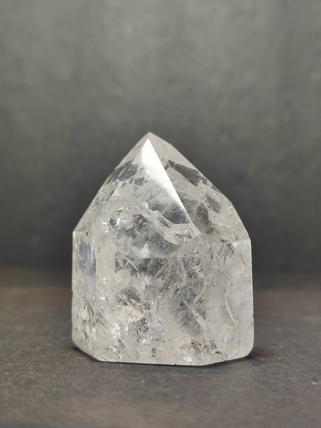 Single clear faceted quartz point with sharp prismatic top