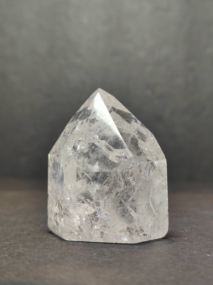 Single clear faceted quartz point with sharp prismatic top