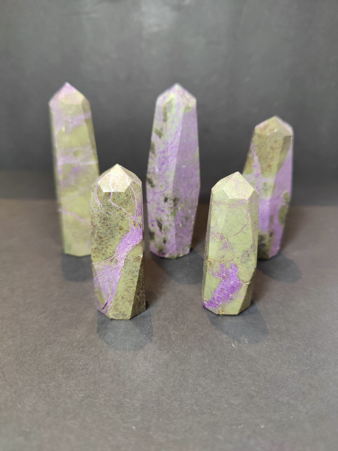 Polished crystal tower sculptures, pale green with purple veining, pointed tops