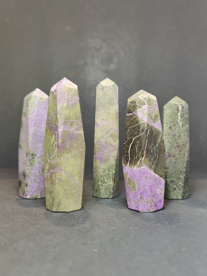 Polished crystal tower sculptures, pale green and lavender marbling, faceted pointed tops