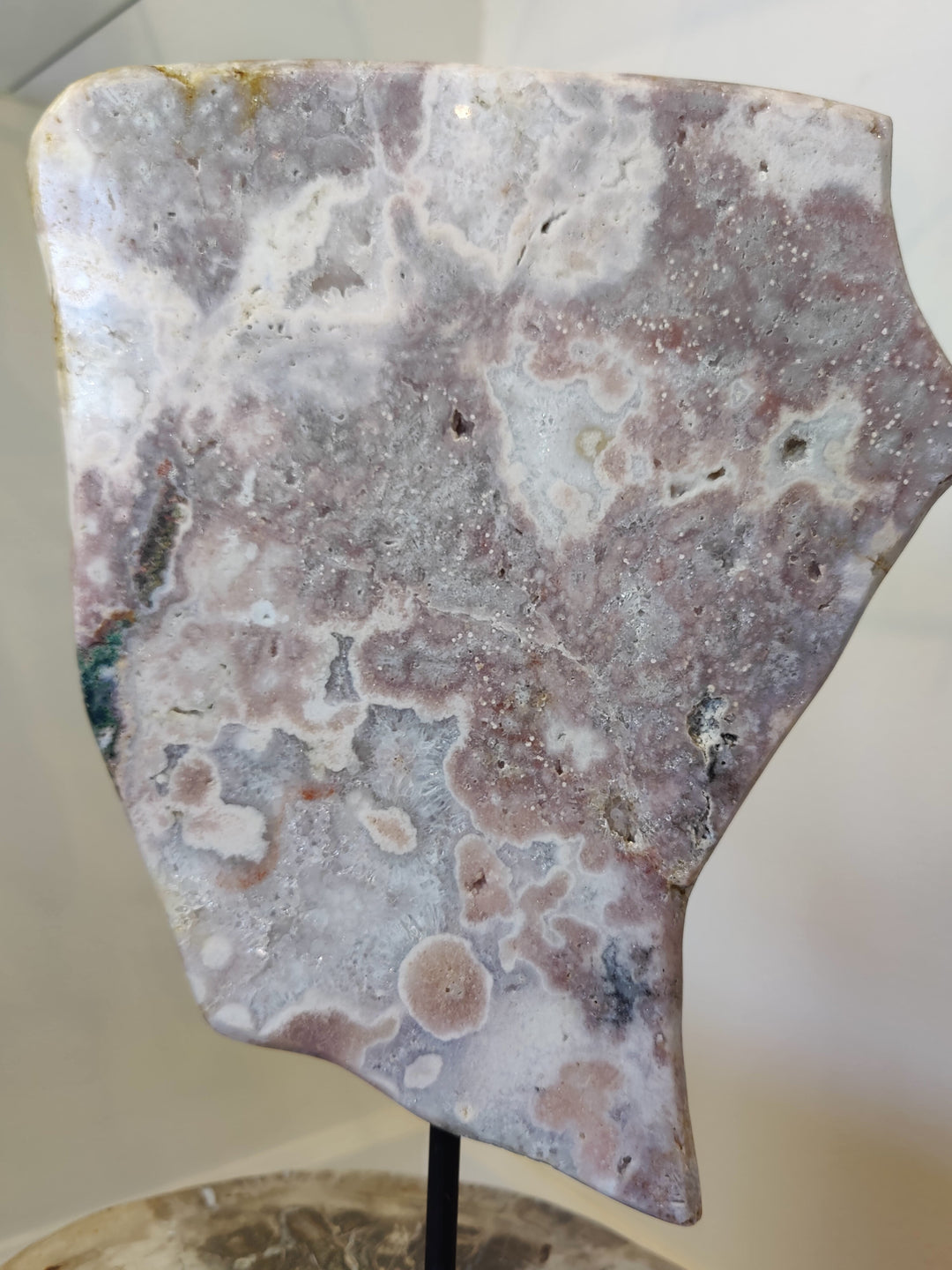 Polished pink amethyst slab sculpture with white and purple mineral patterns