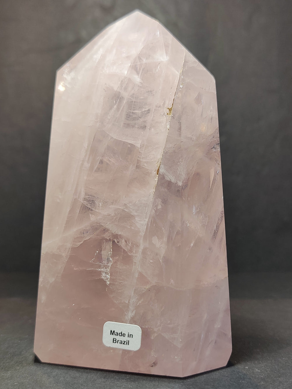 Rose quartz polished obelisk tower, pink translucent with 'Made in Brazil' label