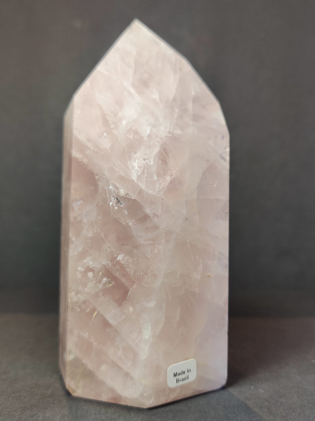 Rose quartz polished obelisk tower, pink translucent with faceted polished surface