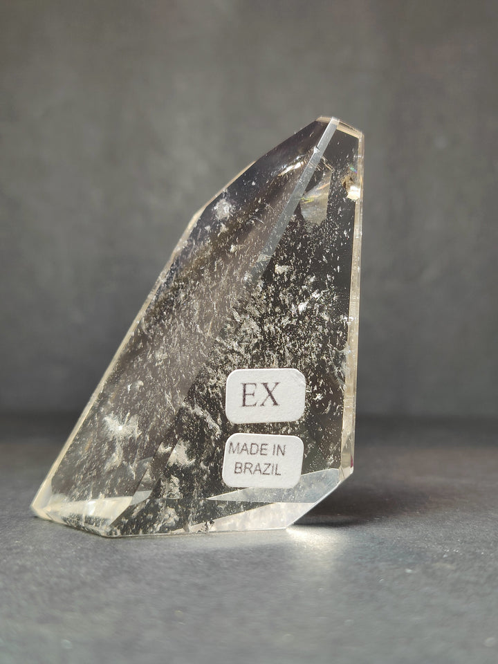 Smoky quartz free-form sculpture with EX and Made in Brazil label on front