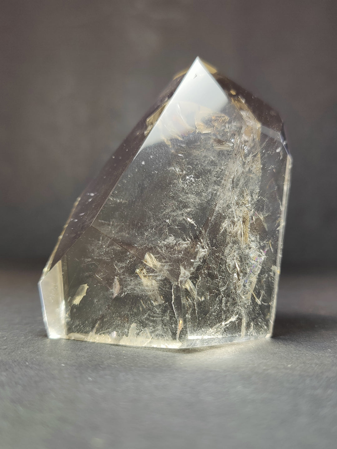 Smoky quartz free-form crystal with reflective facets; label not visible