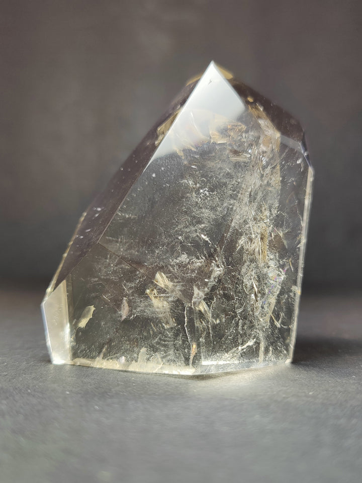 Smoky quartz free-form crystal with reflective facets; label not visible