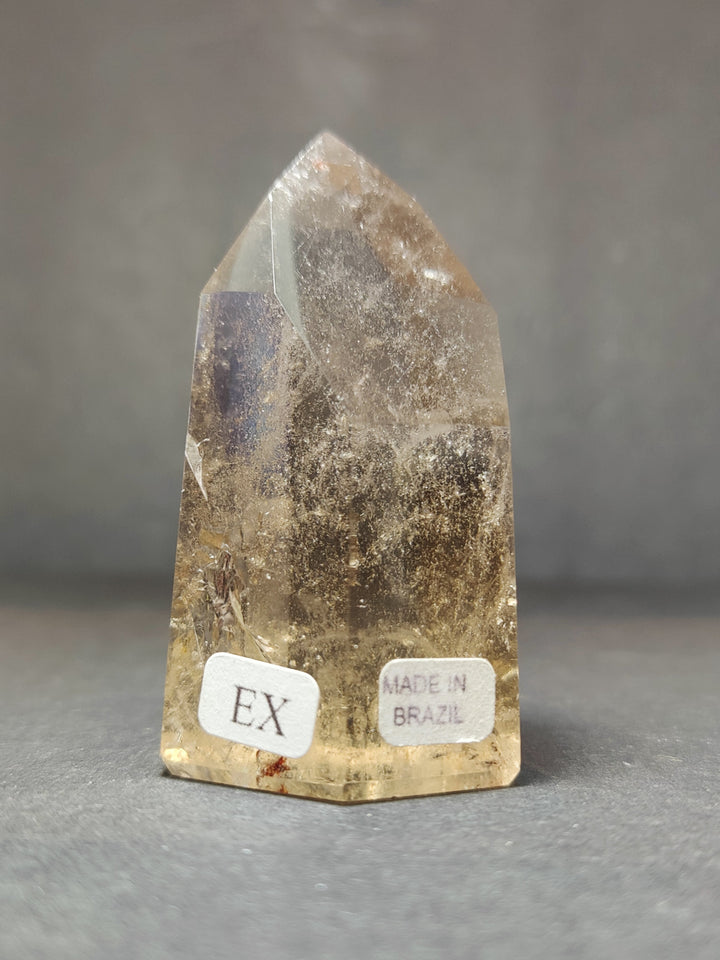 Smoky and clear quartz free-form sculpture with EX and Made in Brazil labels