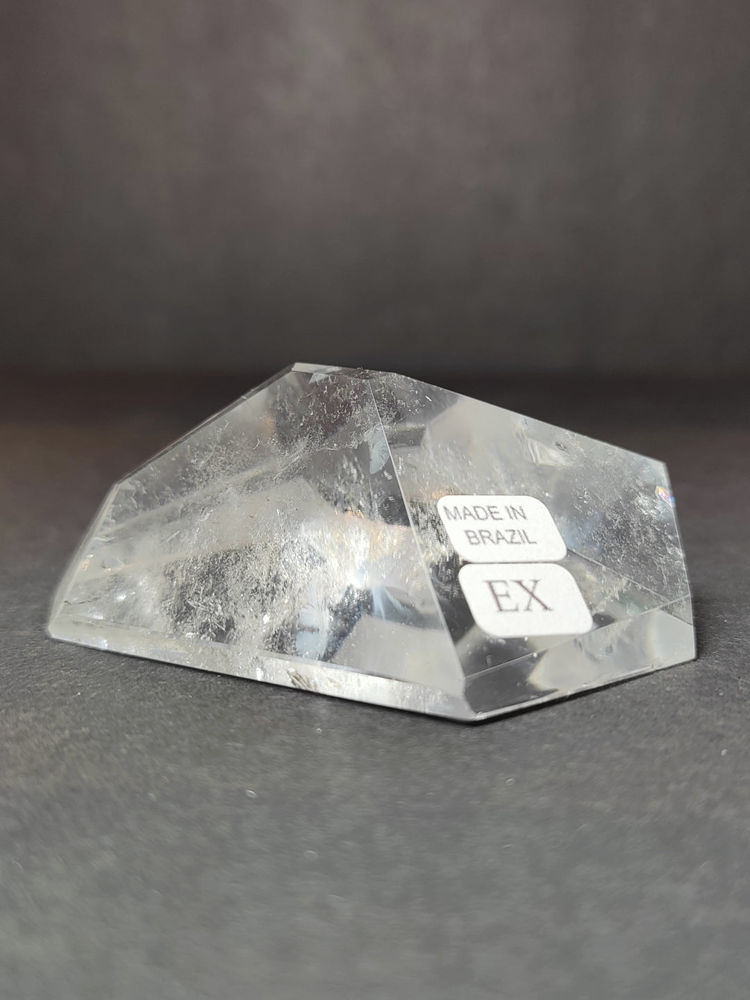 Clear quartz polished free-form tray-like piece with Made in Brazil and EX labels