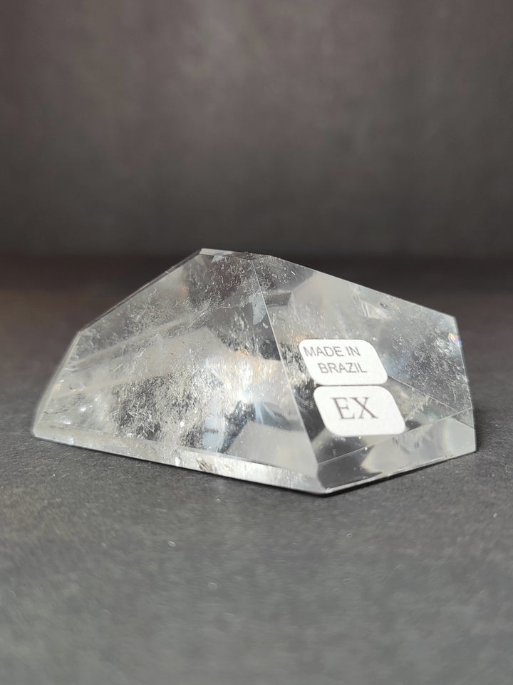 Clear quartz polished free-form tray-like piece with Made in Brazil and EX labels