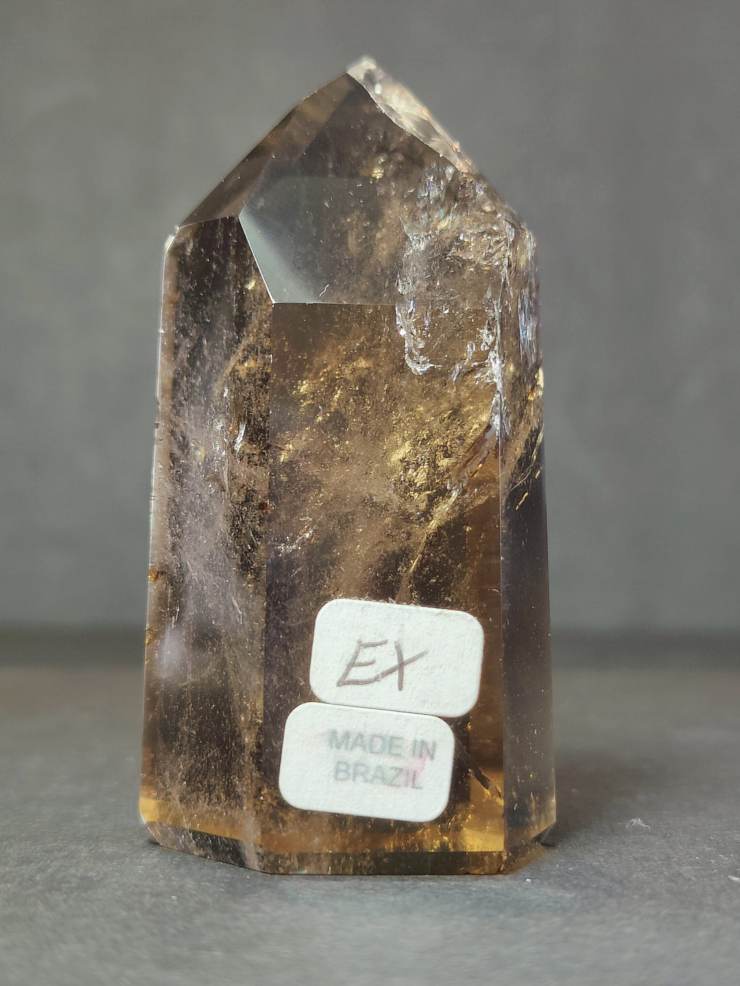 Smoky and clear quartz free-form crystal with EX and Made in Brazil label on base