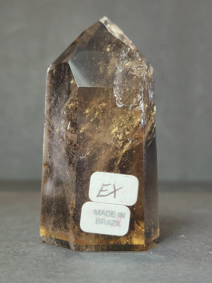 Smoky and clear quartz free-form crystal with EX and Made in Brazil label on base