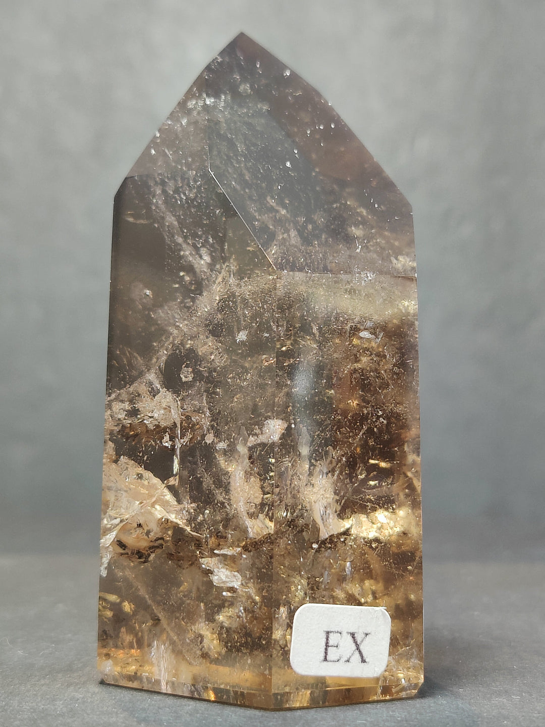 Smoky clear quartz free-form sculpture, polished pointed top, label: EX