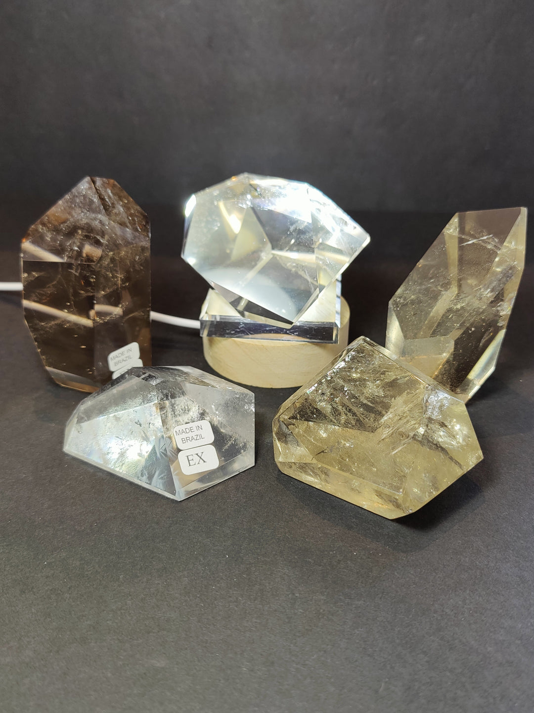 Faceted smoky/clear quartz free-form sculpture; EX and Made in Brazil label visible