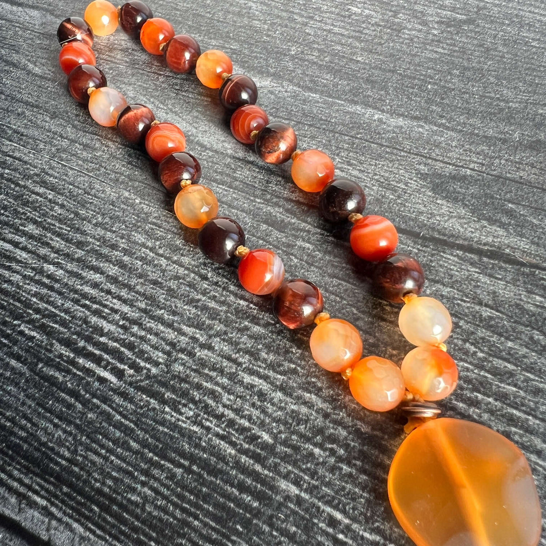 Orange and dark brown bead meditation mala with amber heart pendant