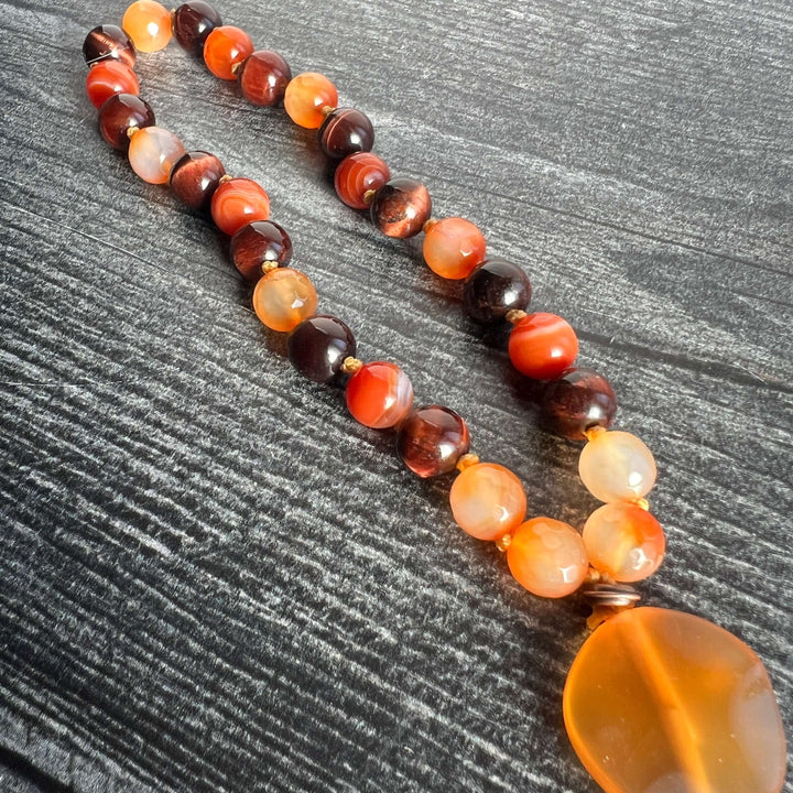 Orange and dark brown bead meditation mala with amber heart pendant