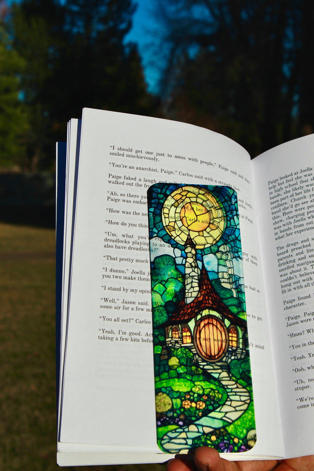 Stained-glass fantasy bookmark with blue-green glass pattern in open book