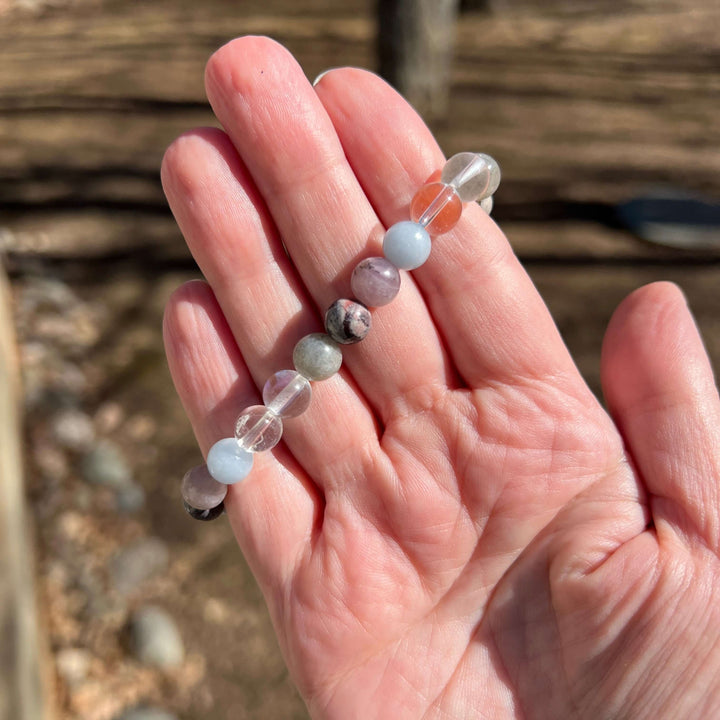 Beaded bracelet with light-blue, gray, and pink stones and clear spacer beads