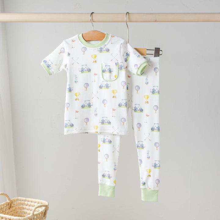 Hanging organic cotton pajama set, white long-sleeve top and pants with green cuffs