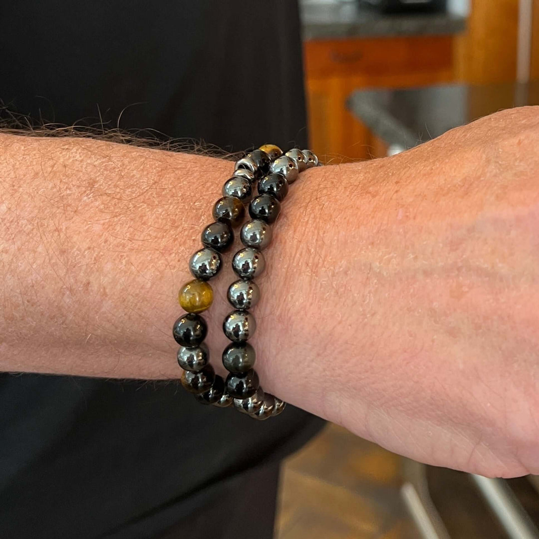 Tiger eye bead bracelet close-up, round dark gray-green beads with gold highlights