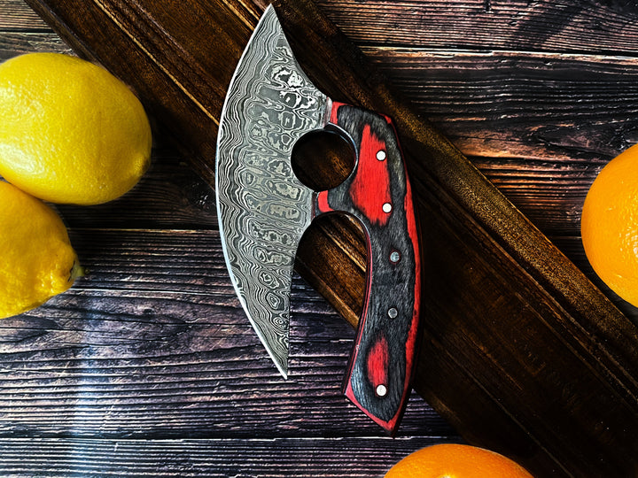 Curved ulu-style blade with etched steel and red-black wooden handle, riveted grips