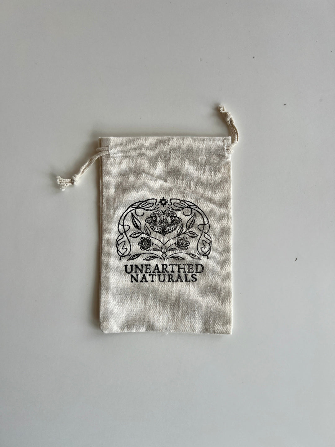 Reusable cotton muslin bath soak bag with drawstring, UNEARTHED NATURALS logo