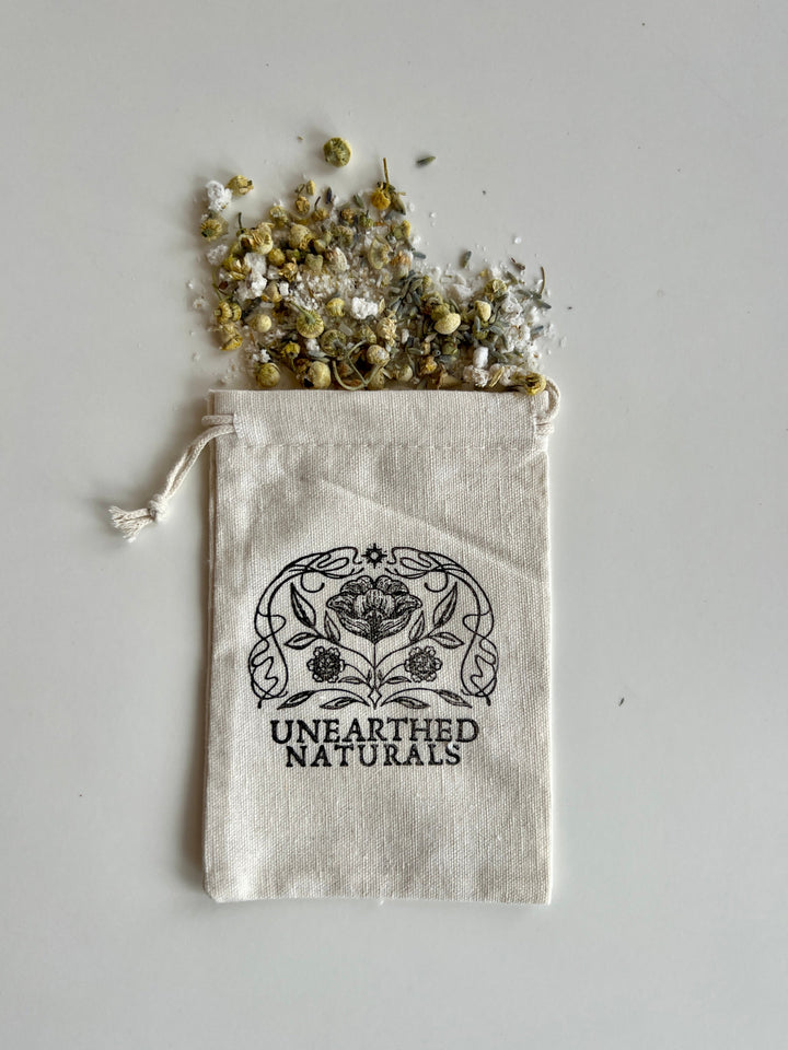 Reusable cotton muslin bath soak bag with drawstring; UNEARTHED NATURALS logo