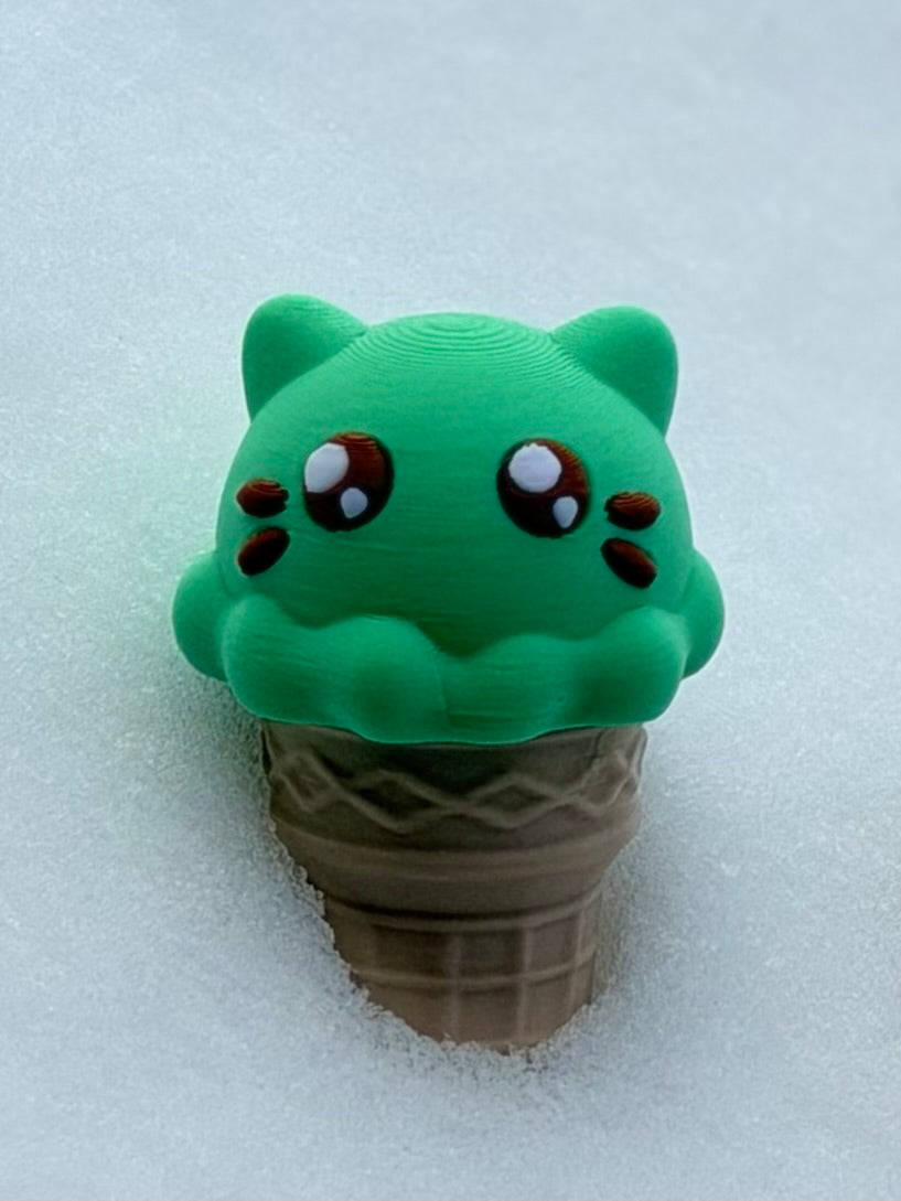 Green cat ice cream fidget with big eyes on beige waffle cone