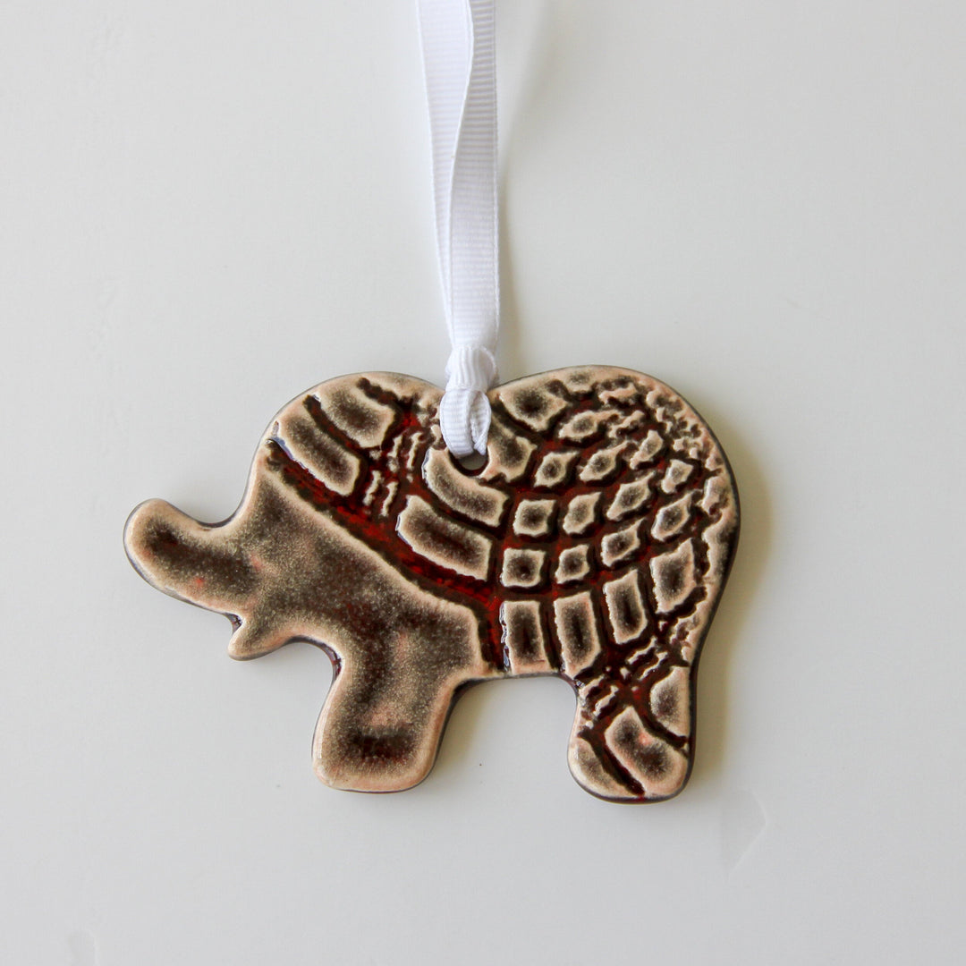 Grey patterned elephant ornament with white hanging ribbon, flat and detailed