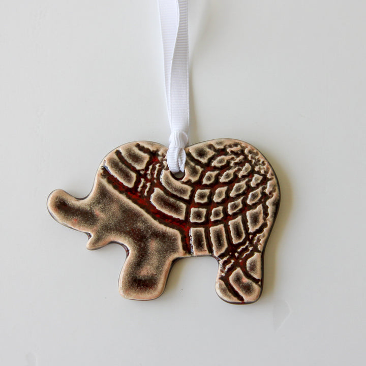 Grey patterned elephant ornament with white hanging ribbon, flat and detailed