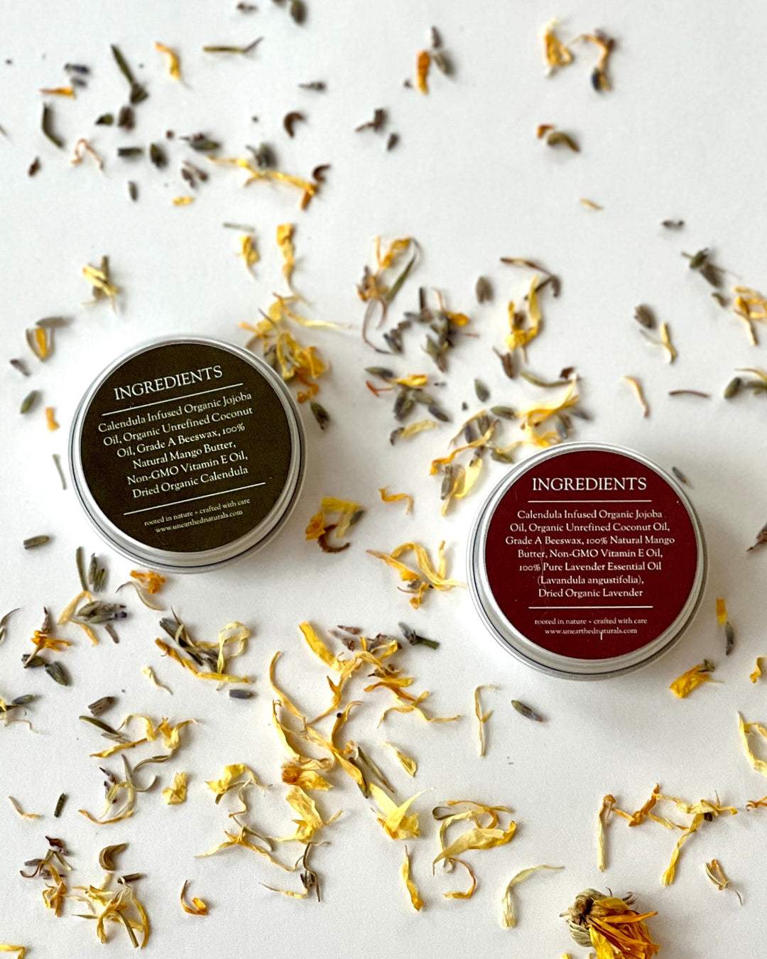 Ingredient-side labels on two balm tins with silver metal lids