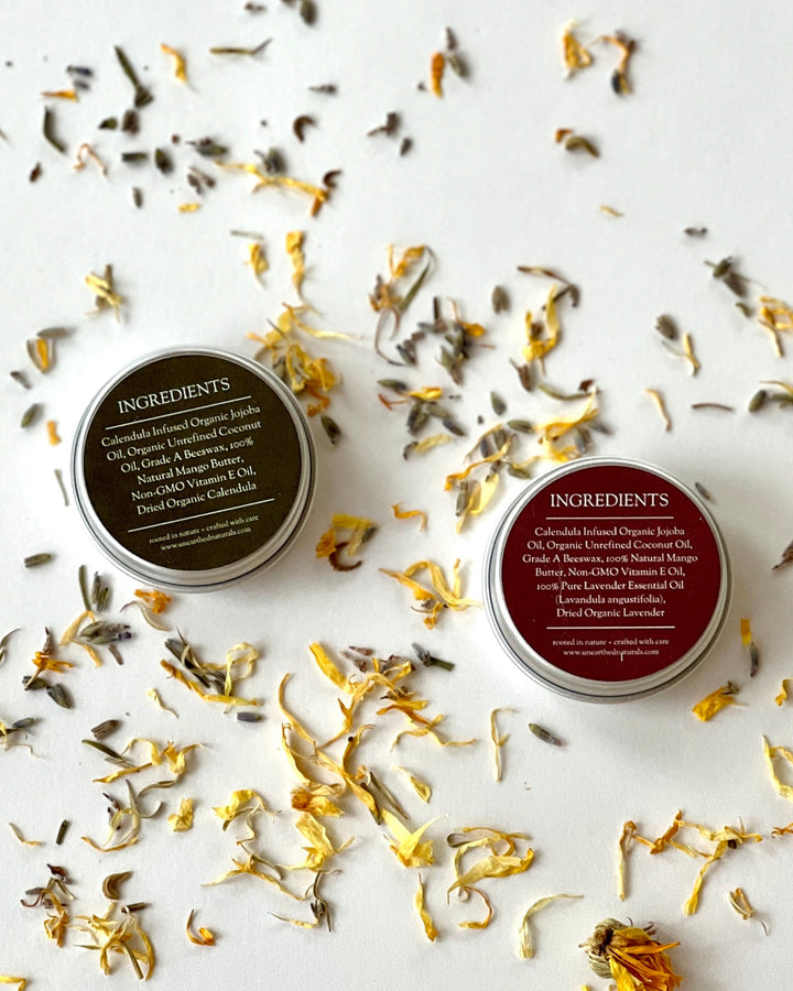 Ingredient-side labels on two balm tins with silver metal lids