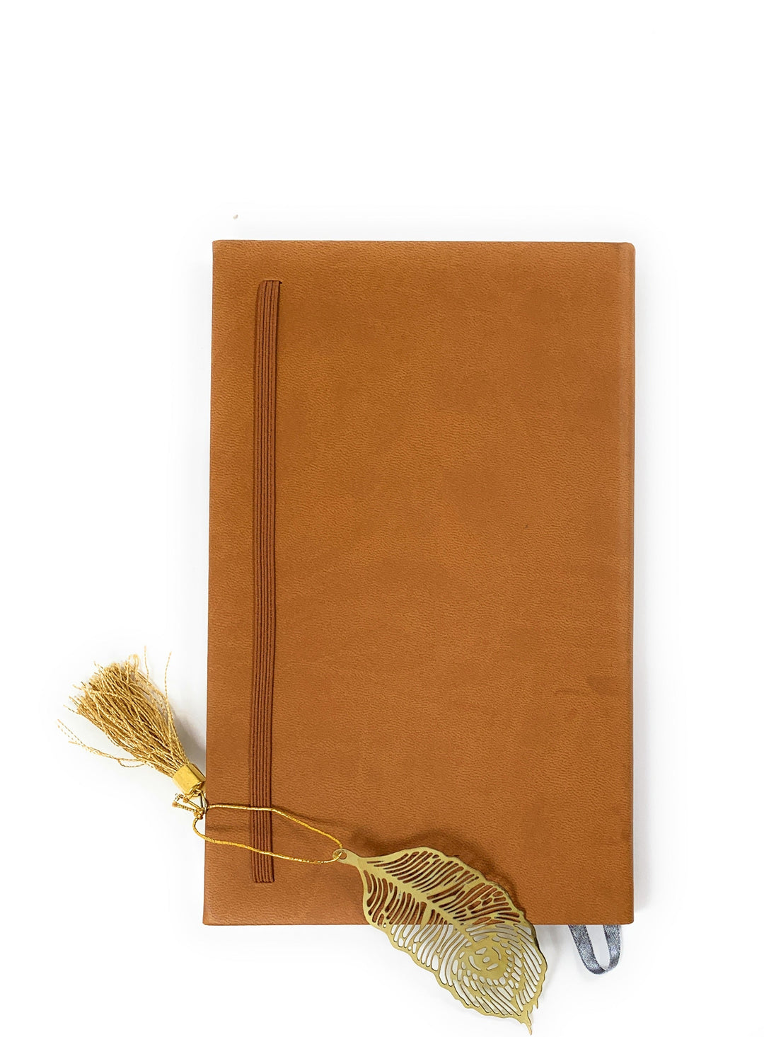 Feather bookmark with gold finish and tassel on brown notebook cover